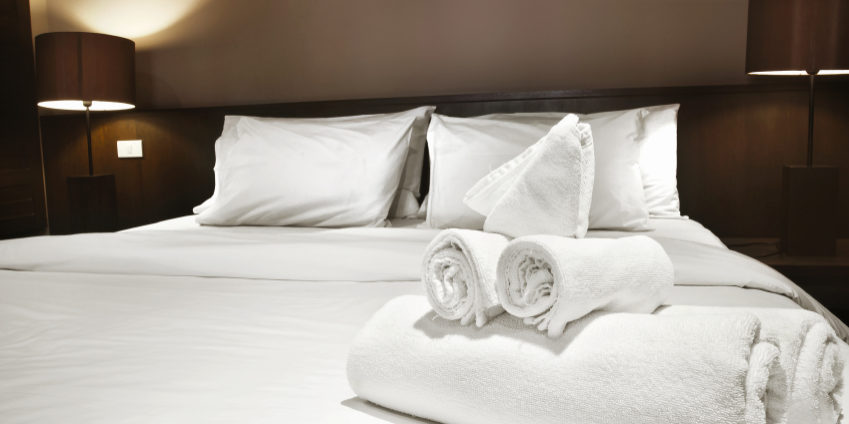 white towels prepared on bed